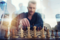 Business Intelligence illustration: businessman play with chess game in office. concept of business strategy and tactic. Double exposure