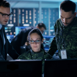 Information Security illusration: government surveillance agency and military joint operation. male agent, female and male military officers working at system control center.