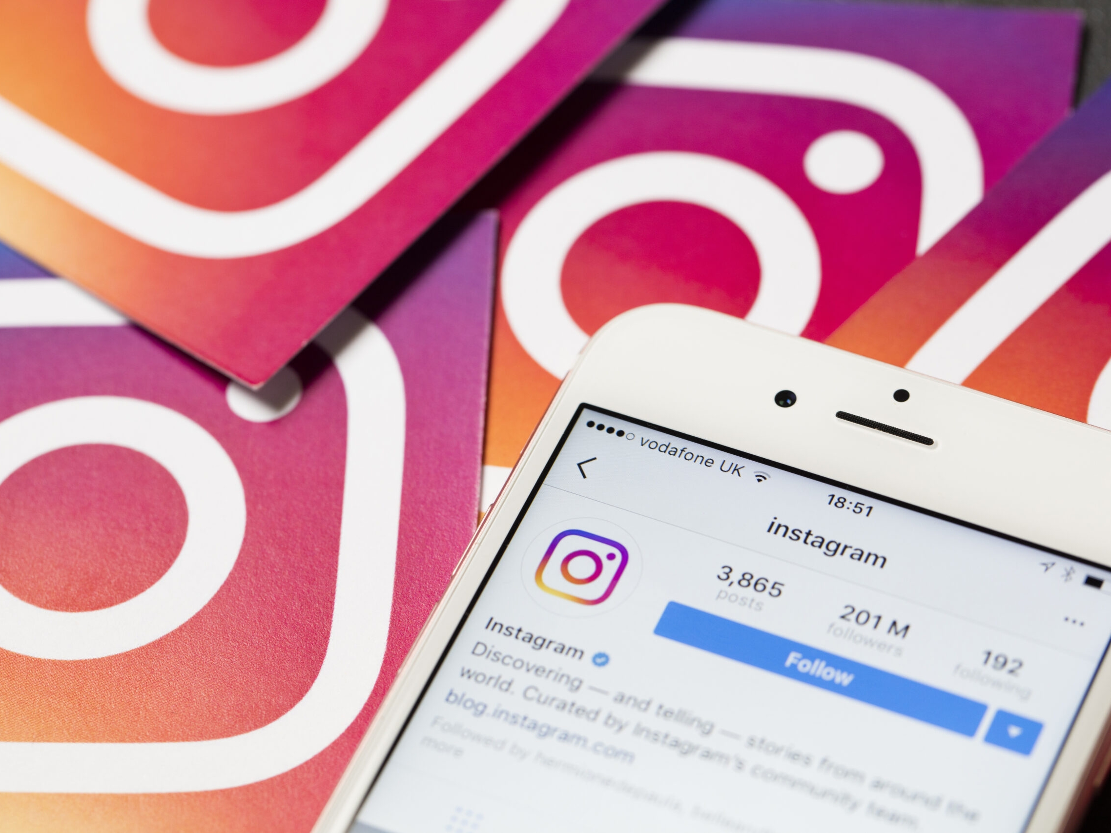 Smartphone shows the instagram app with instagram logos