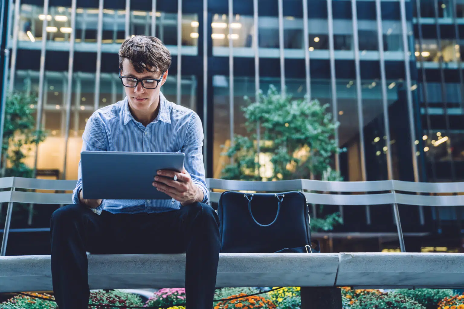 Concentrated businessman reading received email on modern tablet