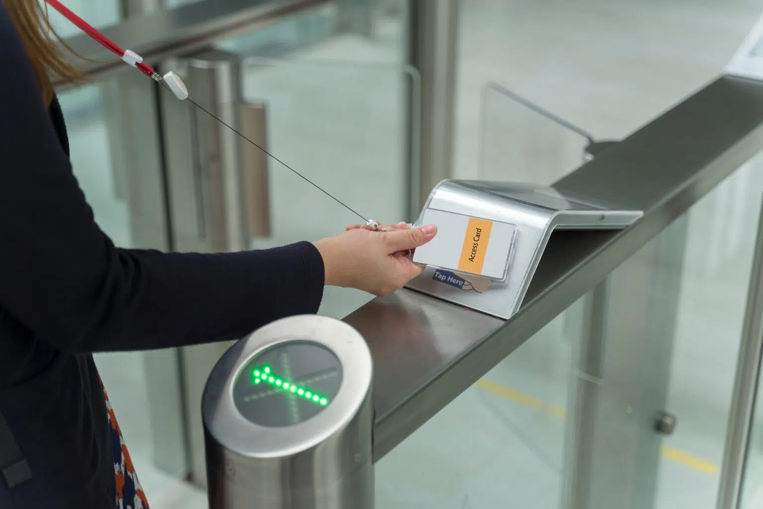 women holding key card access control to unlock security at an entry badgagent